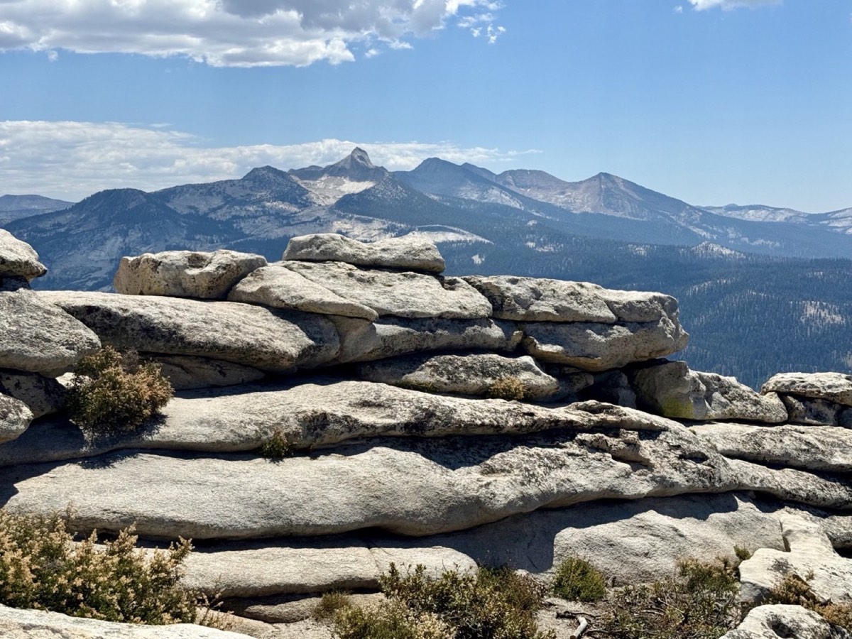 Layered granite slabs and distant peaks from Clouds Rest